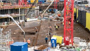A bustling construction site in Hamburg with workers and equipment actively engaged in building tasks.